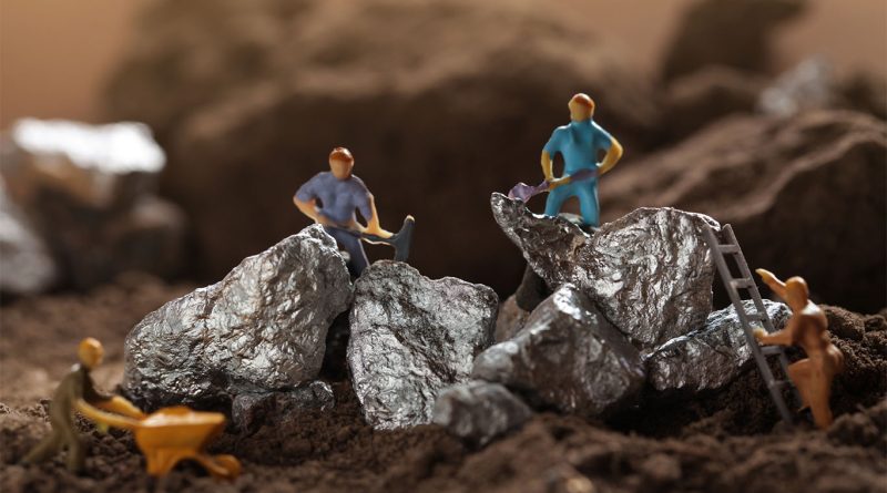 Image of some model construction workers on top of bits of silver with mining tools to support silver mining article