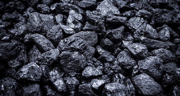 a close-up, high-contrast view of a pile of raw coal.