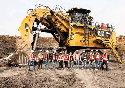  Caterpillar 6040 Hydraulic Mining Shovel positioned on a dirt-covered open mining field or construction site